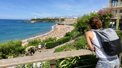 Image of a person facing towards a water body.