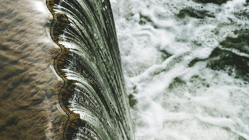 Top view of a waterfall with clear water flowing into a bigger water body - The Dukes Retreat, Khandala