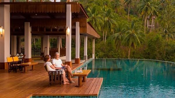 a couple sitting by the swimming pool - Symphony Samudra Beachside Jungle Resort And Spa, Port Blair