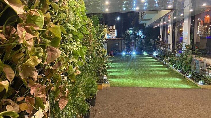 Lobby area of  Vagator Downtown, Goa with plants on the wall