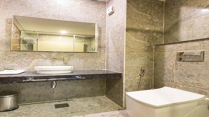 image of a modern bathroom with transparent glass doors at the family room - ZENQ SIGNATURE INN, MCLEODGANJ
