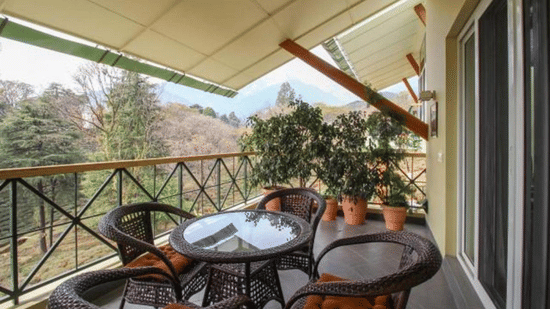 A spacious Balcony with a dining arrangement - Lamrin Hotels & Resorts