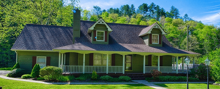 facade image of a villa with an expansive well pruned lawn in front of it - Historic Tapoco Lodge