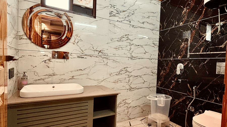 A modern bathroom with a marble-patterned vanity, wood-paneled ceiling, and sleek fixtures - Golden Oak By The Lake Hill, Khurpatal