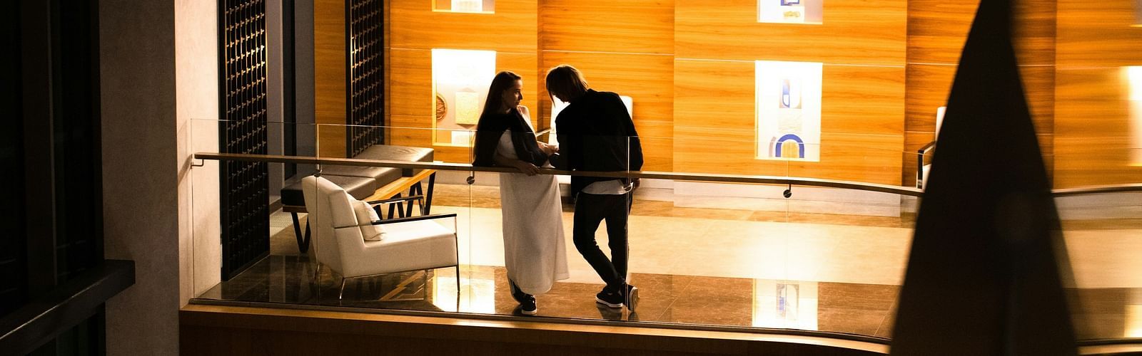 A couple enjoying each other's company in a balcony of a hotel