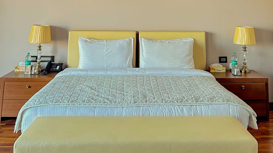 Minimalist bedroom with hardwood flooring and warm ambiance at Aranya Retreat, perfect for a peaceful stay