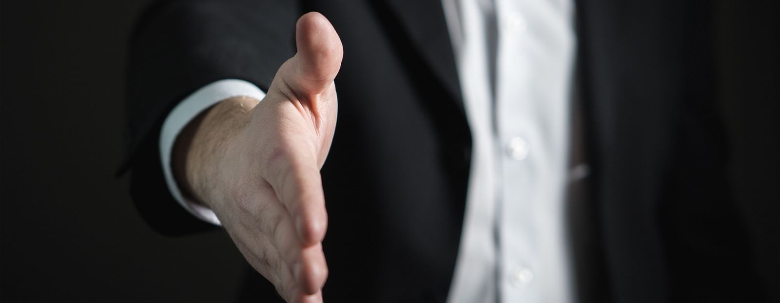 Businessman offering a handshake.