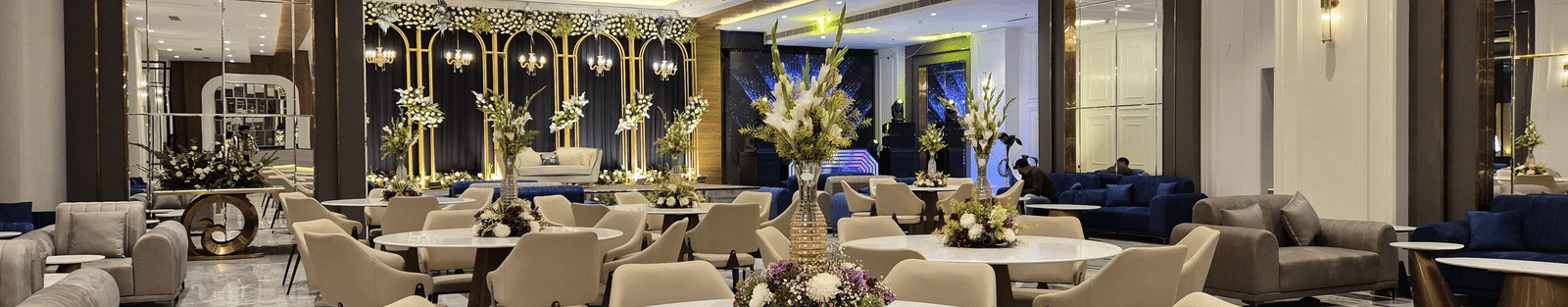 Elegant event space with chandelier lighting and neutral-toned seating, showcasing a sophisticated setting at Ramada by Wyndham Sonipat Murthal