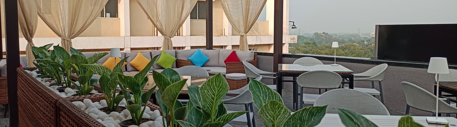Nasha The Rooftop dining area at Wonder Country Club and Resort, Kharagpur featuring elegant seating, open-sky ambience, and side-lined greenery
