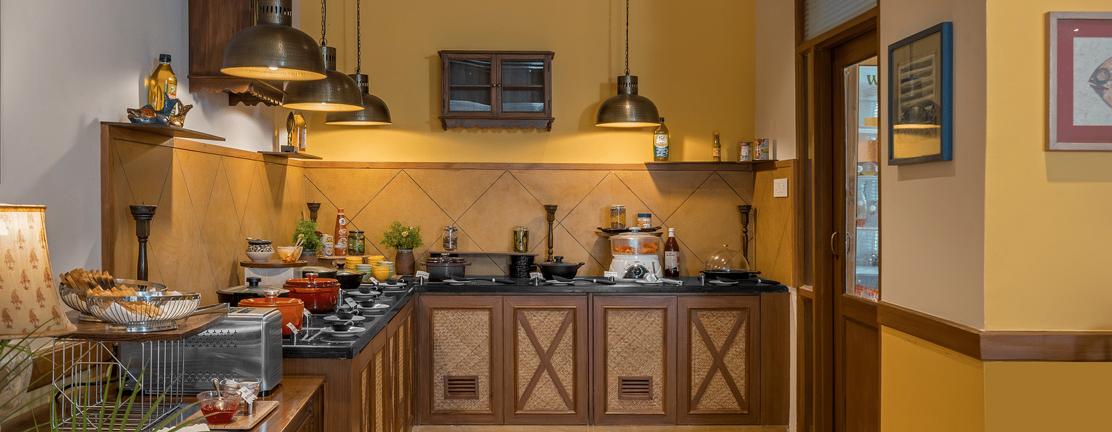 A well-equipped kitchen at Fishermen's Lodge, Bhimtal, featuring modern facilities for a convenient cooking experience.
