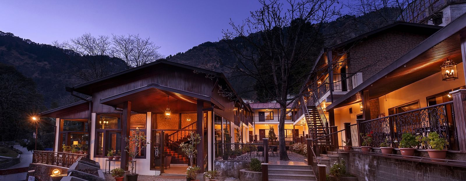 Outdoor dining area at a resort with a mountain view.
