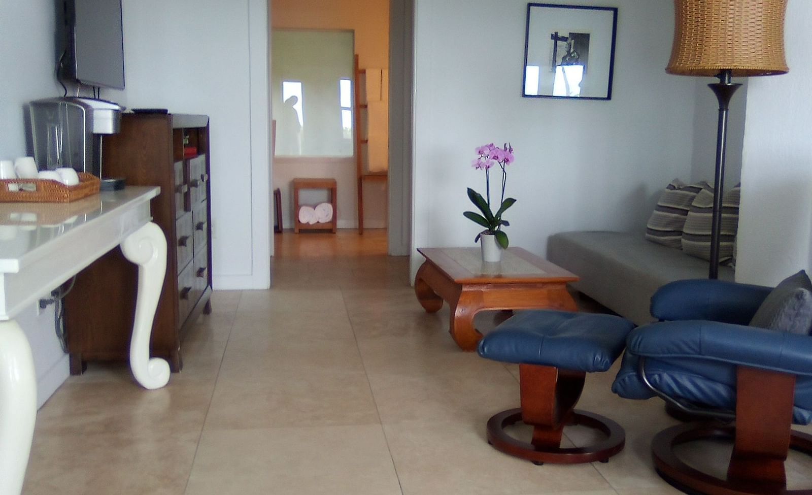 Room at Casa Morada with a bed, wooden furniture, and a sitting area with chairs and a TV.