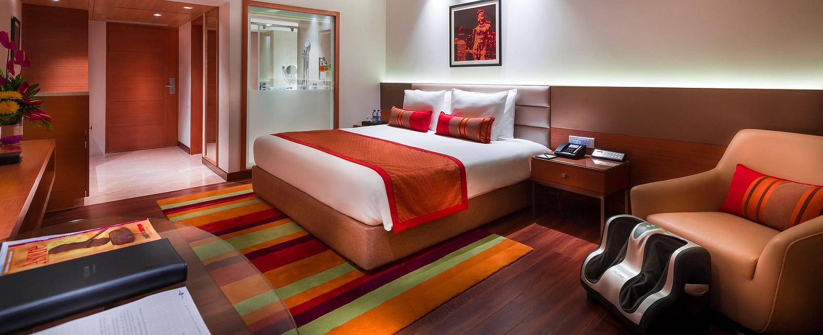 Grand Club Room with king size bed and sofa chair at Grand Chennai By GRT Hotels.