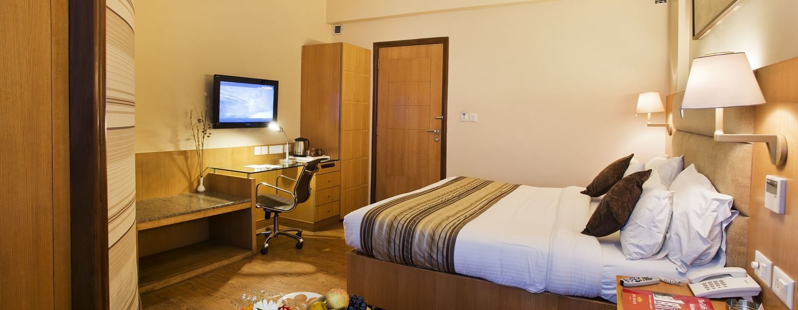 an image of a bedroom with a fan hanging from the ceiling at The Manor, Bareilly
