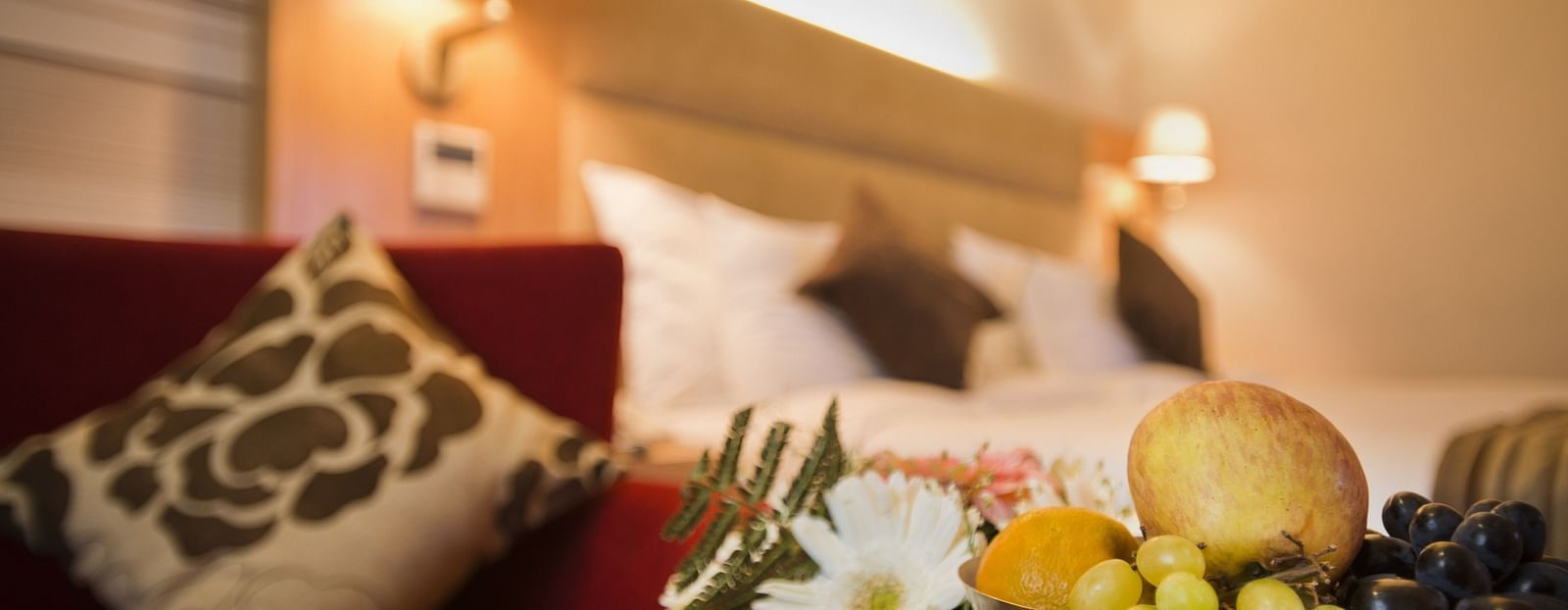 an image of a fruit basket kept beside the bed in a superior room at The Manor, Bareilly