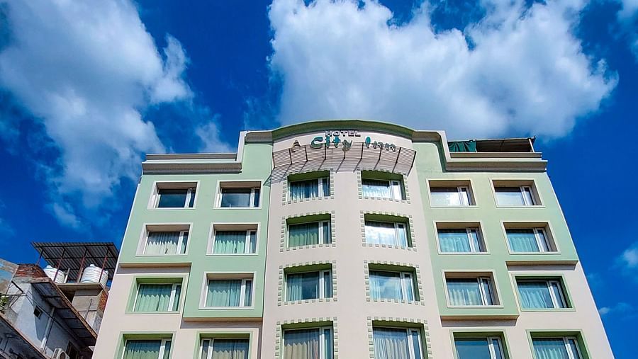  Exterior view of Hotel City Inn, Varanasi, showcasing its multi-storey facade, located in a prime city area with convenient parking.