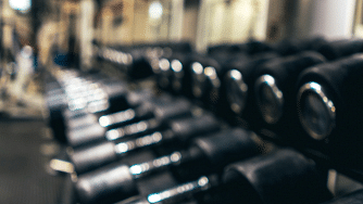 A well equipped gym with dumbbells.
