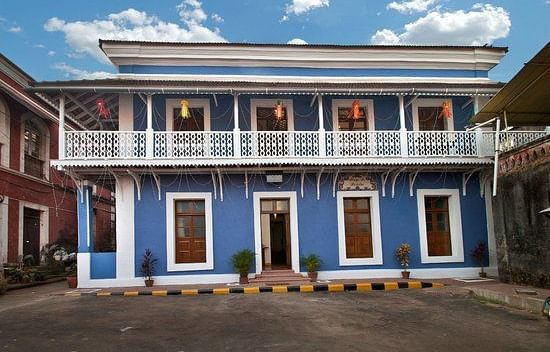 A twi-storey bungalow featuring Portuguese architecture and a  balcony