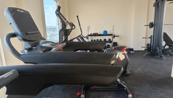 Side view of the treadmill machine along with the cardio cycle in the gym at Leroy Grand, Yeshwanthpur.