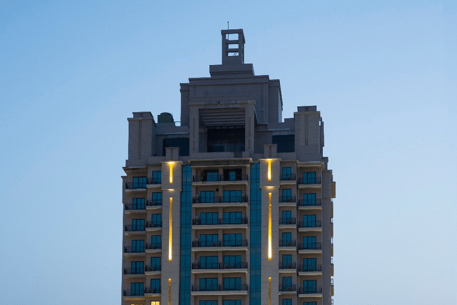 far out facade view of Rhythm Gurugram with the twilight sky in the background.