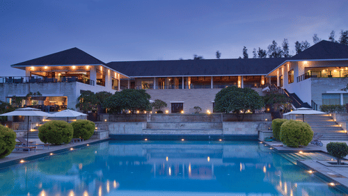 Swimming pool and exterior facade in late evening of The Serai, Chikmagalur.
