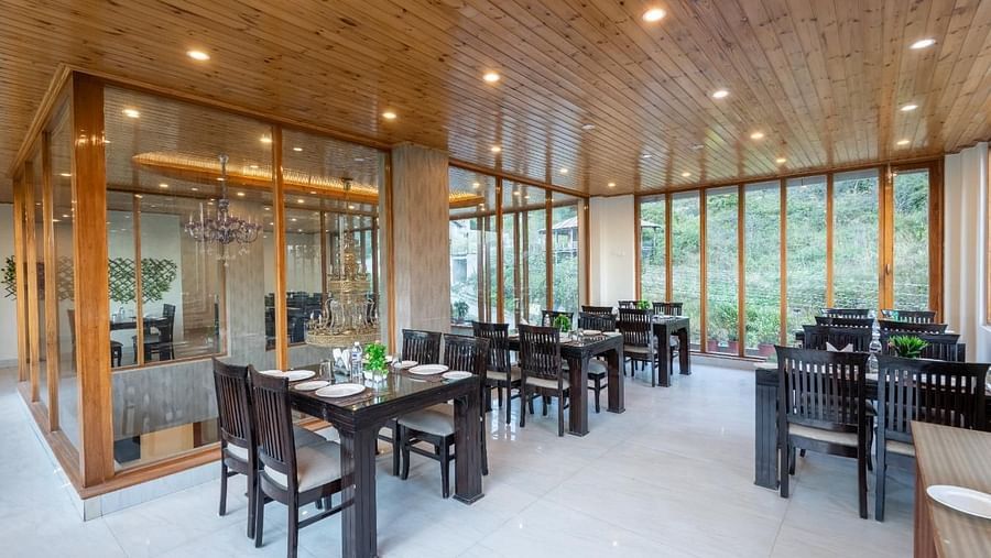 Image of a seating arrangements with tables and chairs, likely designed for both casual and formal dining  | DLS Serenity Resort and Spa