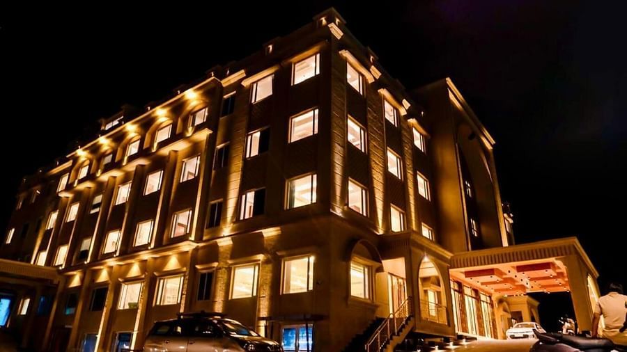 Facade of Le Royale Palace with the lights turned on at nightime.