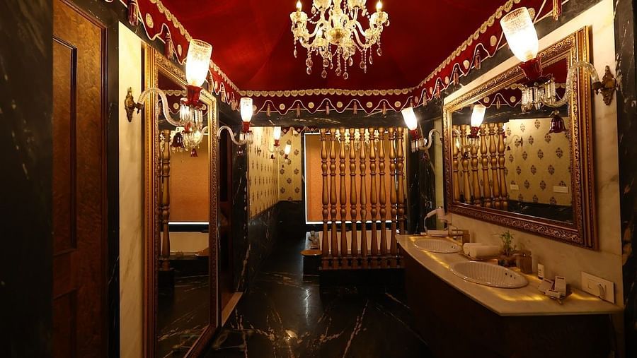 Image of a washroom with two sinks and a chandelier hanging from the ceiling at Rajasthali Resort & Spa Jaipur. 