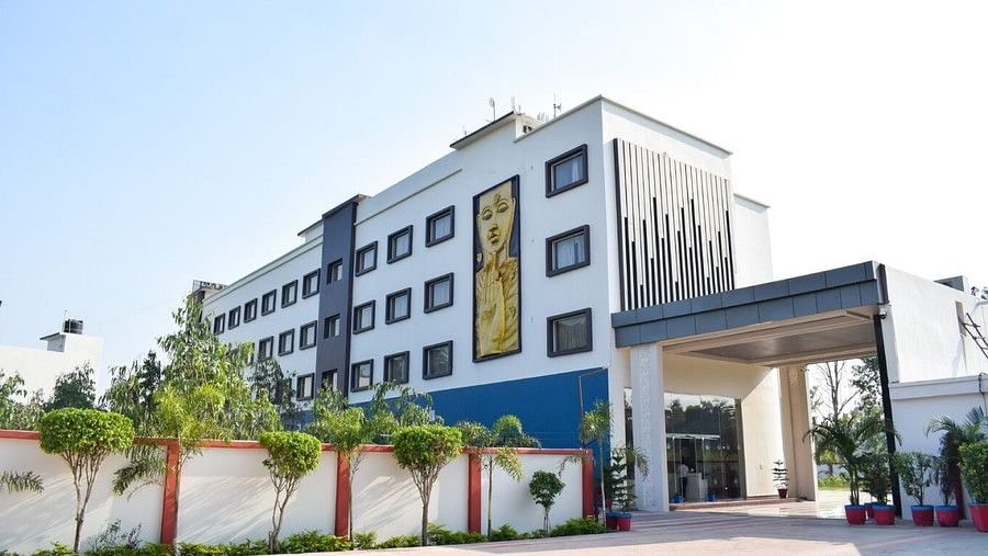 Facade image with the entrance and a painting on the building at Tulip Inn, Shravasti