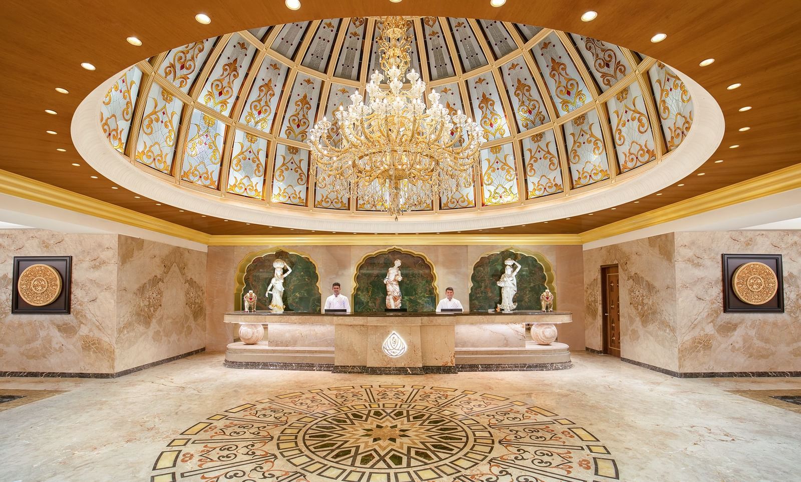 A reception area with a reception desk, receptionists and a giant chandelier - Kaldan Samudhra Palace