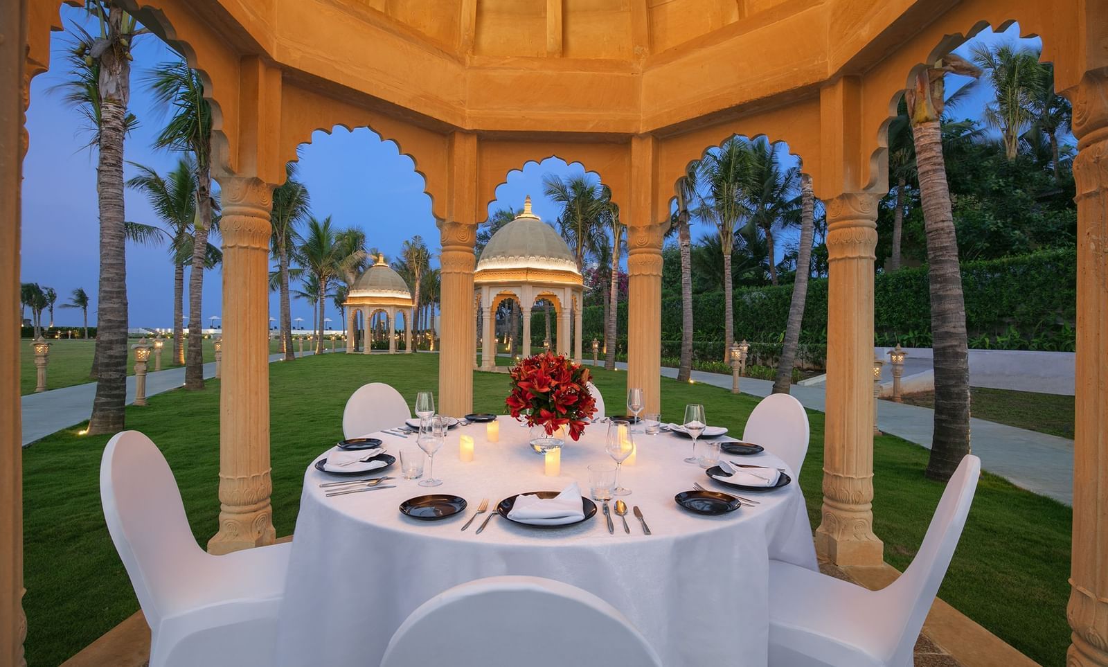 A gazebo with a dining setup, cosy lighting and views of the sea - Kaldan Samudhra Palace