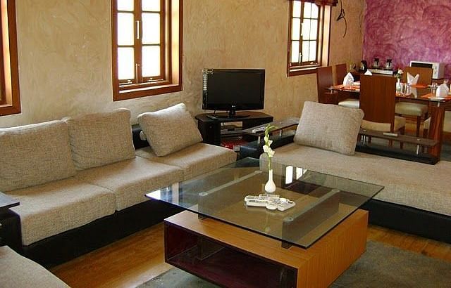 Living area featuring sofa sets arranged around the coffee table