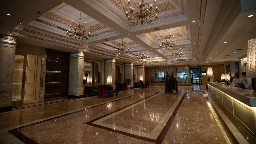 Grand hotel lobby with marble flooring and chandeliers