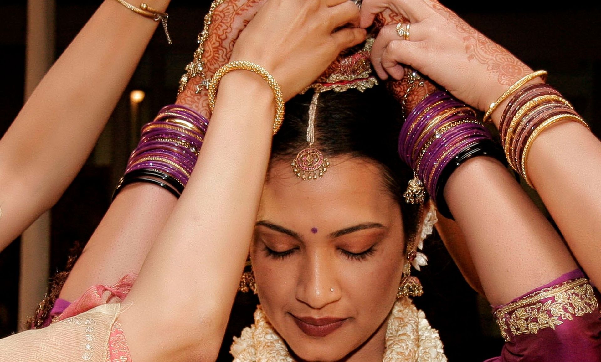 Kodava bride during a wedding, hands with bangles.