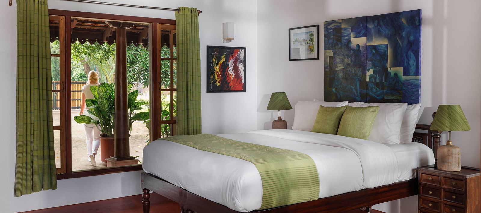 A room with a bed, wooden decorative items, and a glass window overlooking the view - BluSalzz Villas - Muhamma Resort, Alleppey