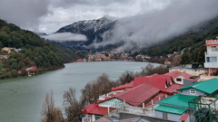 A top view of a beautiful village by a lake 