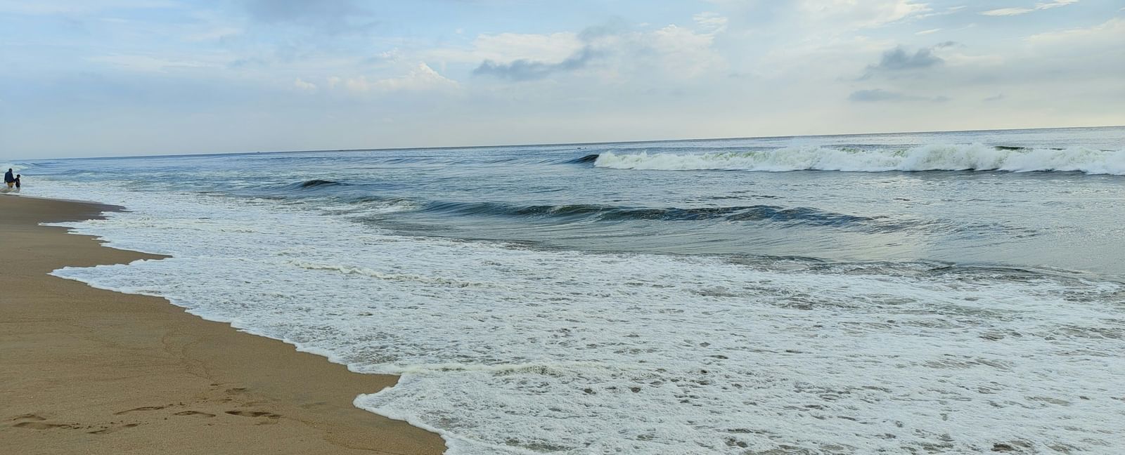 An overview of a beach with the waves overlapping the shoreline.