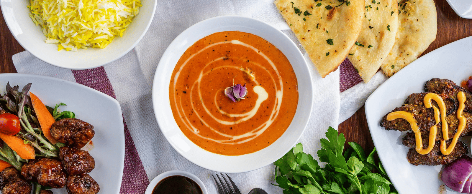 A top shot of a delicious spread of various Indian dishes served on a table.