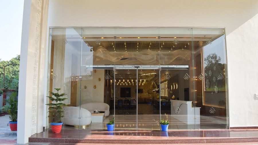 Entrance to the hotel with floor to ceiling windows at Tulip Inn, Shravasti