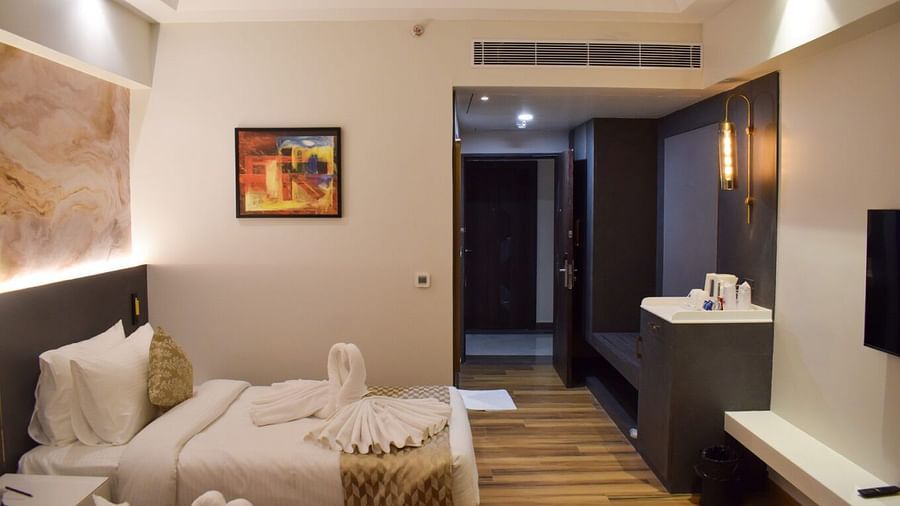 Twin beds with a painting on the side of the wall at Executive Room at Tulip Inn, Shravasti