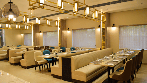 Side view of the seating arrangements inside tulipe restaurant at Tulip Inn, Shravasti
