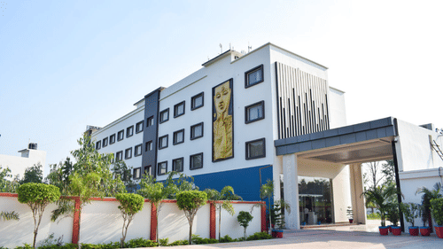 Facade image with the entrance and a painting on the building at Tulip Inn, Shravasti