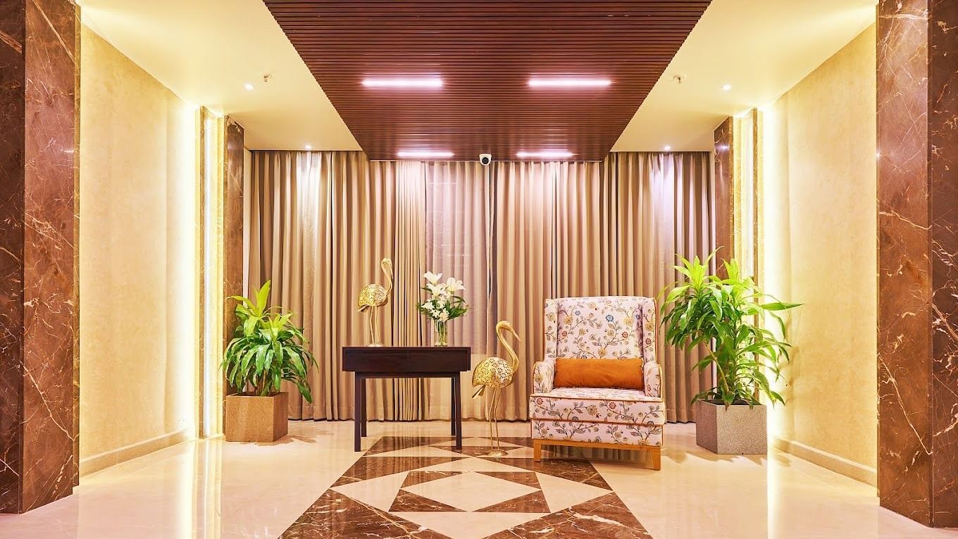 A tale and a sofa kept in the Corridor of Visthara - Urban Boutique Hotel, Bangalore