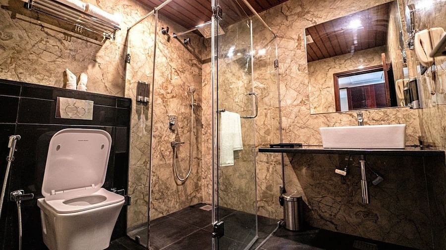 Image of a washroom with sink, toilet and bath area at Visthara - Urban Boutique Hotel, Bangalore