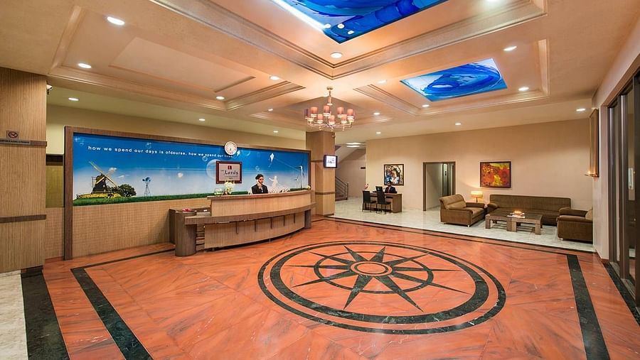 An ornate lobby features patterned flooring, comfortable seating, and unique lighting - Lion Lords Inn Rajula