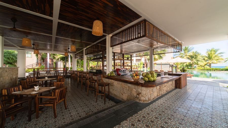 An image of a restraunt that has different kinds of fruits and chairs are placed on the other side - Alibu Resort Nha Thrang