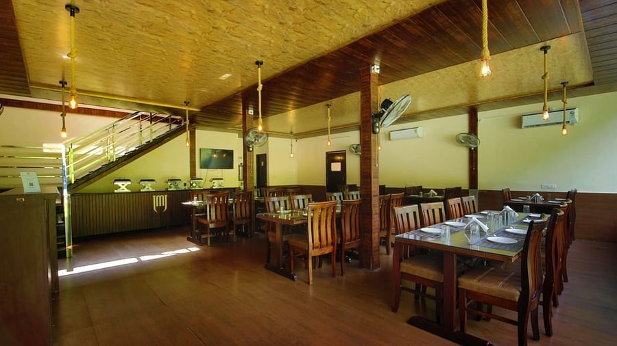 Dining area of the in-house restaurant at DLS MJ River Resort, Rishikesh.