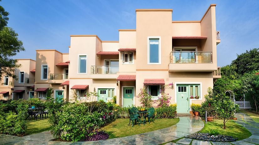 A facade image of the villas surrounded by greenery - Karma Lakelands.