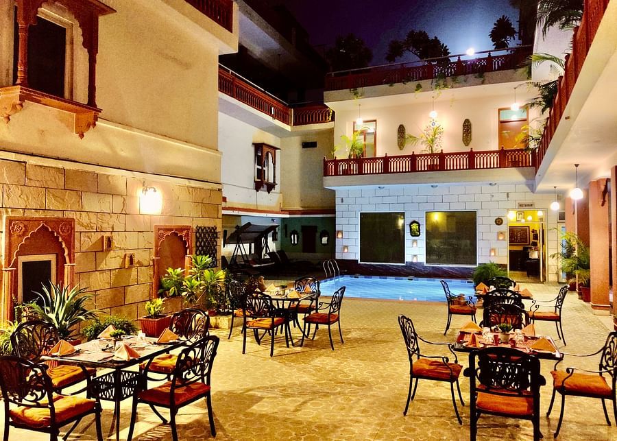 Seating arrangement at Poolside Courtyard Dining at Suryaa Villa Jaipur