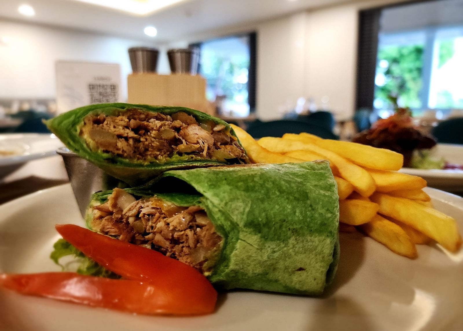 A wrap with fries and fresh veggies on the side - Hotel 39, Jamaica